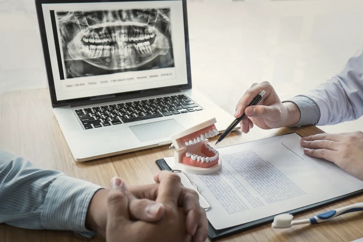 Itemised dental investment estimate document at a planning desk