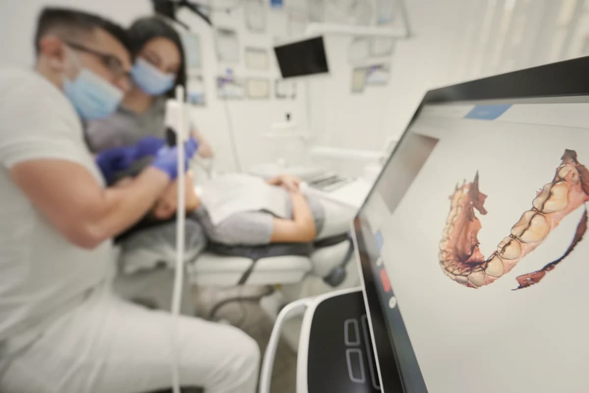 Remote evaluation — clinician reviewing CBCT scan on a planning monitor